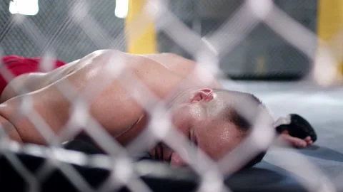 MMA fighter is falling on the floor after being hit and gets up quickly to Stock Footage 155647811