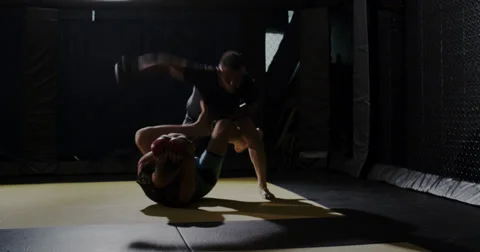 MMA fighter laying down vicious elbows in the ring. Stock Footage 33526971