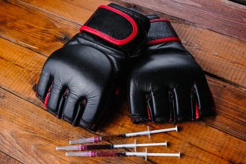 Mma gloves and steroid medication composition on a wooden background Stock Photos