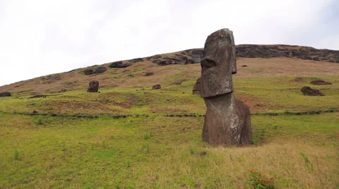 Moai statue standing proudly down the hill Stock Footage 64258651