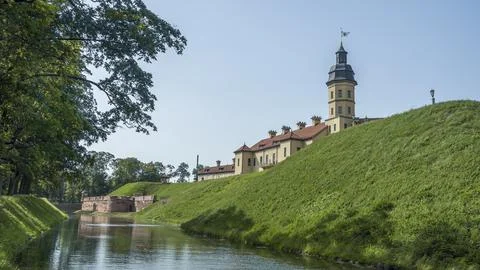 Moat of old castle. Moat with reflection in the water and trees. Sunny summer Stock Photos