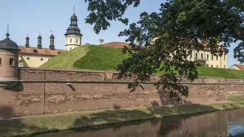 Moat of old castle. Moat with reflection in the water and trees. Sunny summer Stock Photos