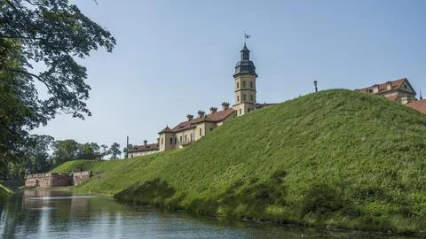 Moat of old castle. Moat with reflection in the water and trees. Sunny summer Stock Photos
