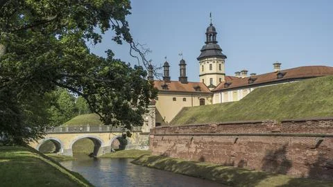 Moat of old castle. Moat with reflection in the water and trees. Sunny summer Stock Photos