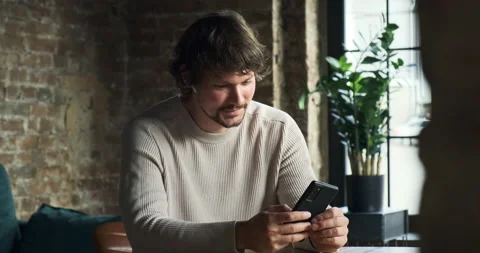 Mobile addicted man use smartphone all time at home Stockbeeldmateriaal 156871578