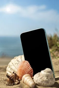 Mobile and shells on the sand - vertical format Stock Photos