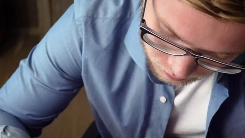 Mobile app developer sketching design of a new app in his notebook Stock Footage
