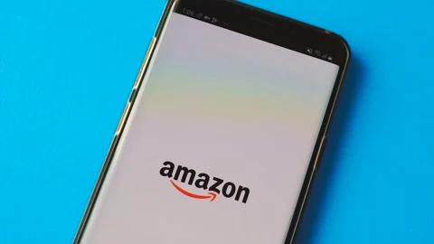 The mobile application of the Amazon store is installed on a smartphone, close-u Stock Footage 208898808