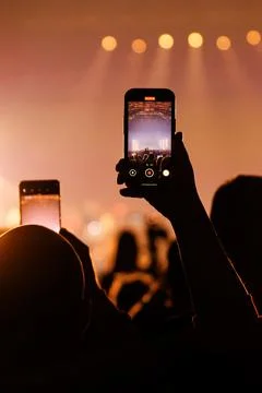 Mobile background vertical fan recording concert on smartphone Stock Photos