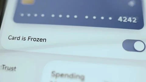 Mobile banking interface switches card ending 4242 from active to frozen Stock Photos