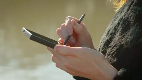 Mobile banking transaction processing through smartphone and stylus over Stock Footage 331207448