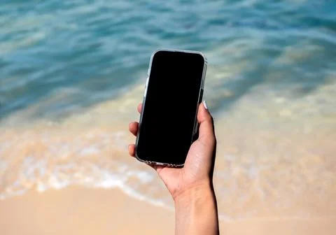 Mobile beach phone with empty screen. Mockup image of black blank desktop s.. Stock Photos