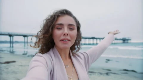 Mobile camera front portrait smiling girl with brunette curly hair taking selfie 스톡 동영상 252244724