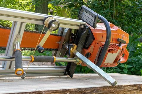 Mobile chainsaw mill with which to cut oak logs on wide boards Stock Photos