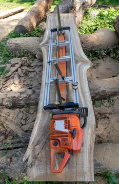 Mobile chainsaw mill with which to cut oak logs on wide boards Stock Photos