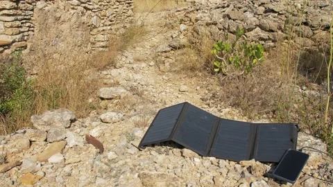 Mobile charging by Solar Panel. Hand disconnect the Cable from the mobile Stock Footage 145981785