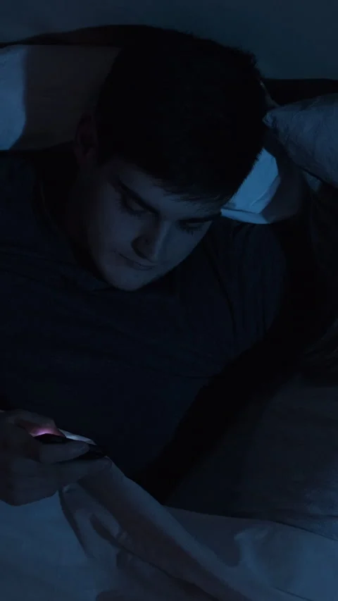 Mobile cheating sneaky husband phone bed vertical Stock Footage 230128422
