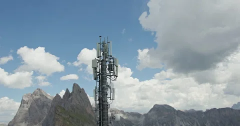Mobile communication tower against rugged Dolomite mountains and dramatic Vídeo Stock 340794463
