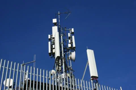 Mobile communication tower on the background of the sky Stock Photos