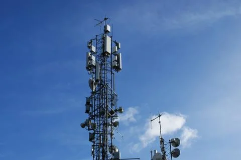 Mobile communication tower on the background of the sky Stock Photos