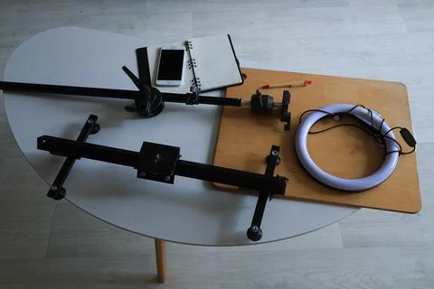Mobile content creation setup with ring light and camera rig on table Stock Photos