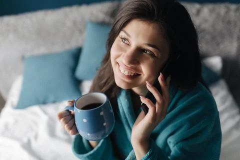 Mobile conversation in bed Stock Photos