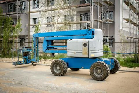 Mobile crane at construction site. Boom lift outdoors. Telescopic elevator fo Stock Photos