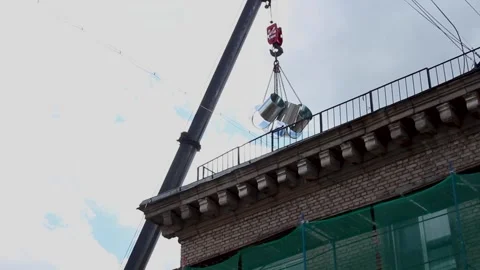 Mobile crane lifting heavy metal ventilation ducts to the rooftop Stock Footage 341833967