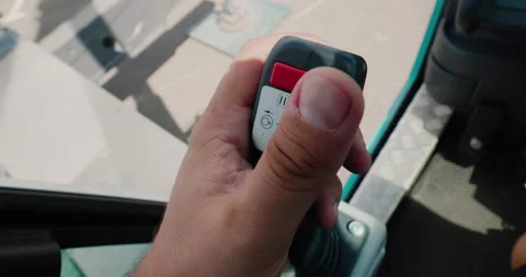 A mobile crane operator's hand holding a joystick to control a crane mechanism. Stock Footage 138078926