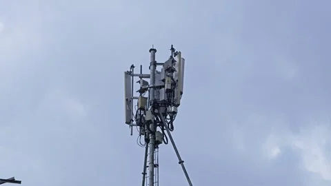Mobile data transmission tower with antennas against a blue clear sky. Stock Footage 307594054