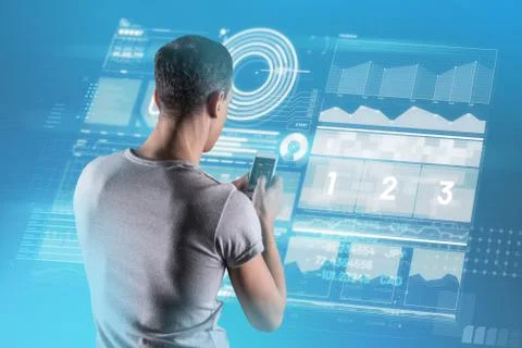 Mobile developer holding a smartphone while working Stock Photos