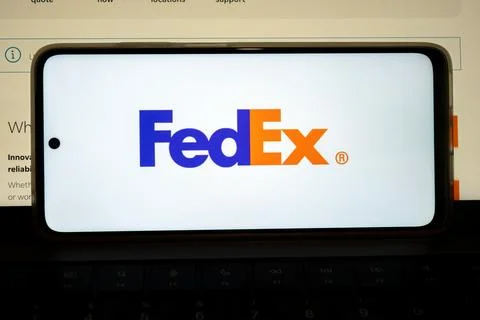 Mobile device displaying fedex shipping and logistics brand Stock Photos