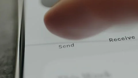 Mobile finance app showing Send button being tapped Stock Footage 332507567