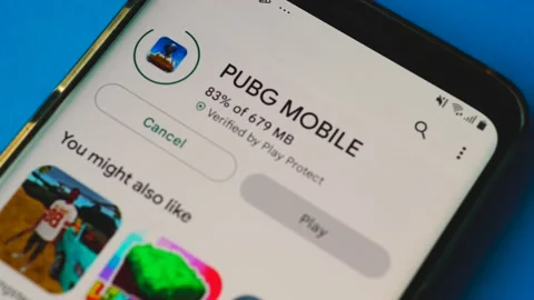 The mobile game PUBG MOBILE is launched on a smartphone, close-up. Logo of the P Stock Footage 207402197