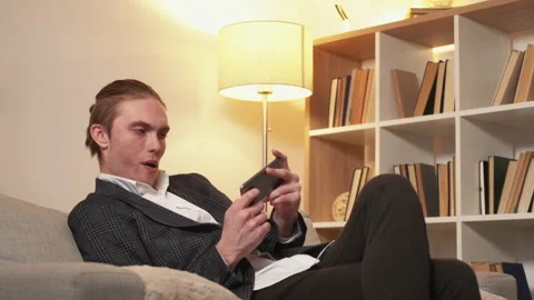 Mobile gaming business man playing on smartphone Stock Footage 201738109