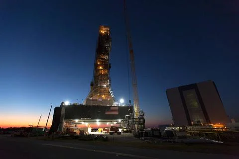 The mobile launcher (ML) tower is lit up before early morning sunrise at N... Stock Photos
