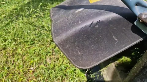 A mobile lawnmower driving through a lawn while mowing Stock Footage 309979793