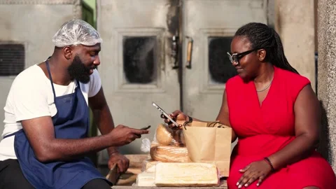 Mobile money payment at bread bakery with smartphone, cashless fintech in Africa Stock Footage 346565913