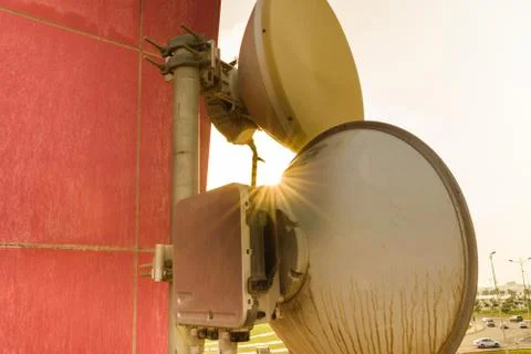 Mobile network access point antenna and tower on the roof top of the building Stock Photos