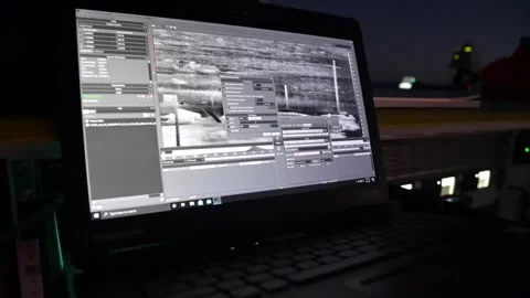 Mobile Optics technician using laptop computer at dusk for space rocket launch Stock Footage 235312787