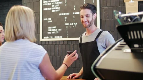 Mobile payment in busy cafe Video stock 58126545