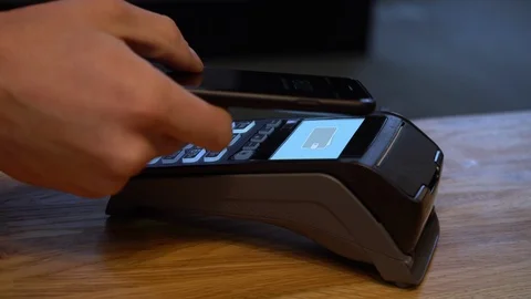 Mobile payments. Payment for purchases with a mobile phone with NFC technology Stock Footage