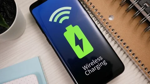Mobile Phone Being Charged On a Wireless Charging Pad Stock Footage 122013851