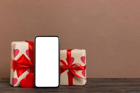 Mobile phone with blank screen on colored background with hearts, calendar an Stock Photos