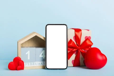 Mobile phone with blank screen on colored background with hearts, calendar an Stock Photos