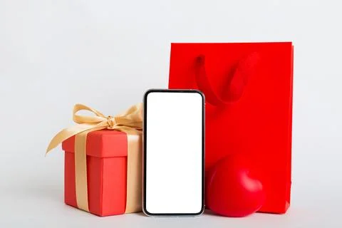 Mobile phone with blank screen on colored background with hearts, calendar an Stock Photos