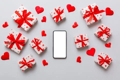 Mobile phone with blank screen on colored background with hearts, valentine d Stock Photos