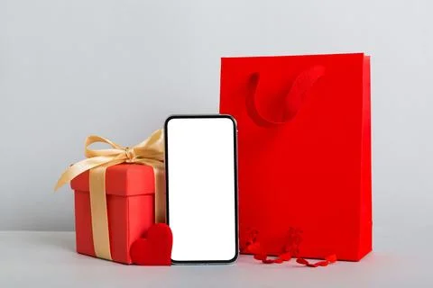 Mobile phone with blank screen on colored background with hearts, calendar an Stock Photos