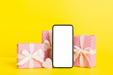 Mobile phone with blank screen on colored background with hearts, calendar an Stock Photos