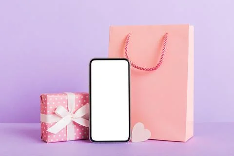Mobile phone with blank screen on colored background with hearts, calendar .. Stock Photos